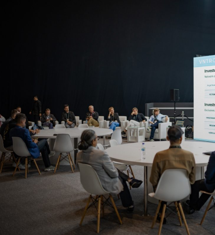 An investor roundtable in a dark hall