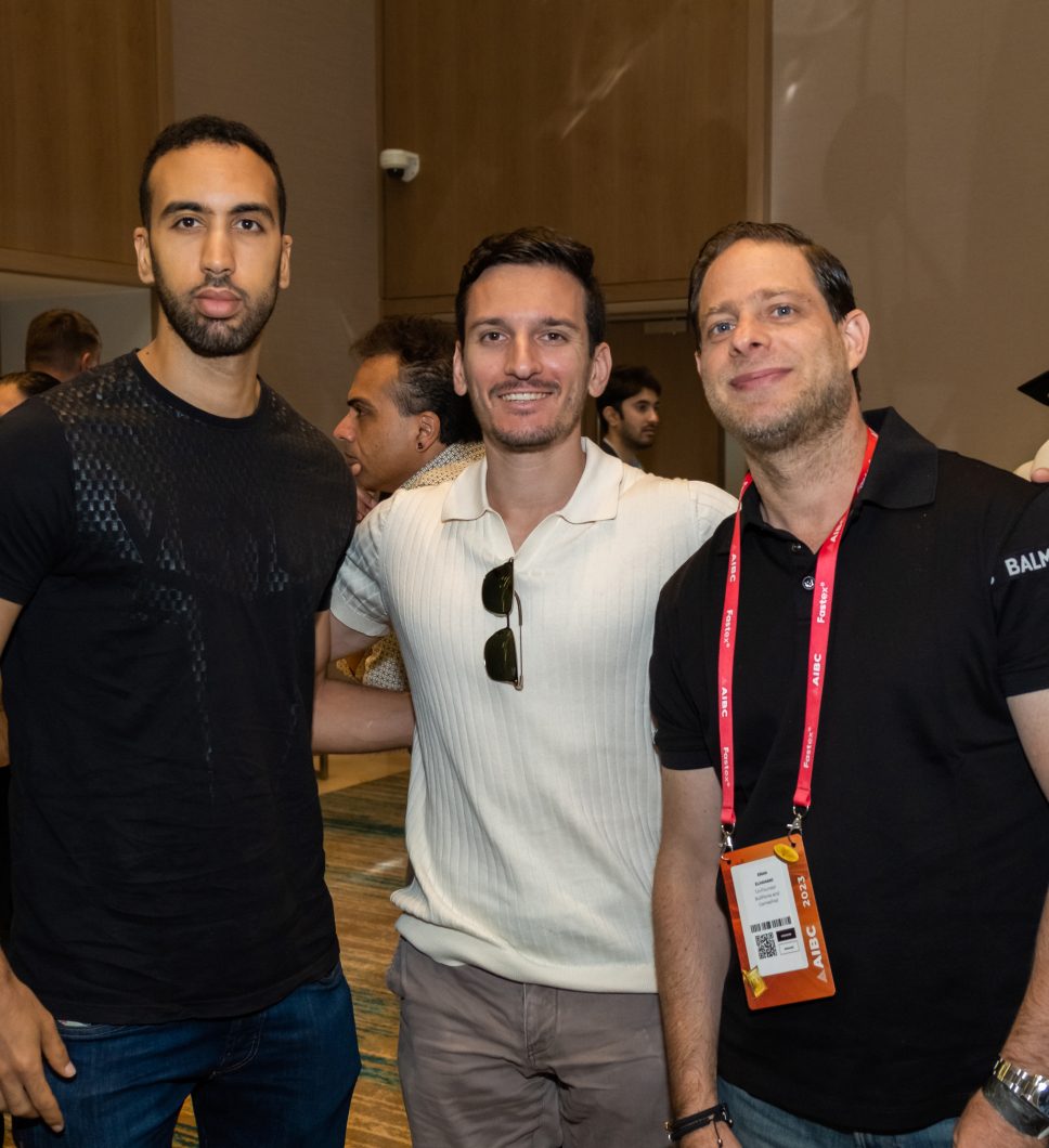 Three guests smiling at a VNTR event